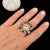 Anillo dorado y erizo marino sobre negro
